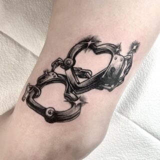 close heart shaped handcuff tattoo