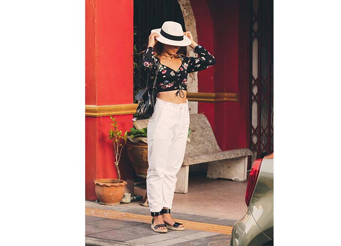 girl wearing black printed wrap top with beige joggers