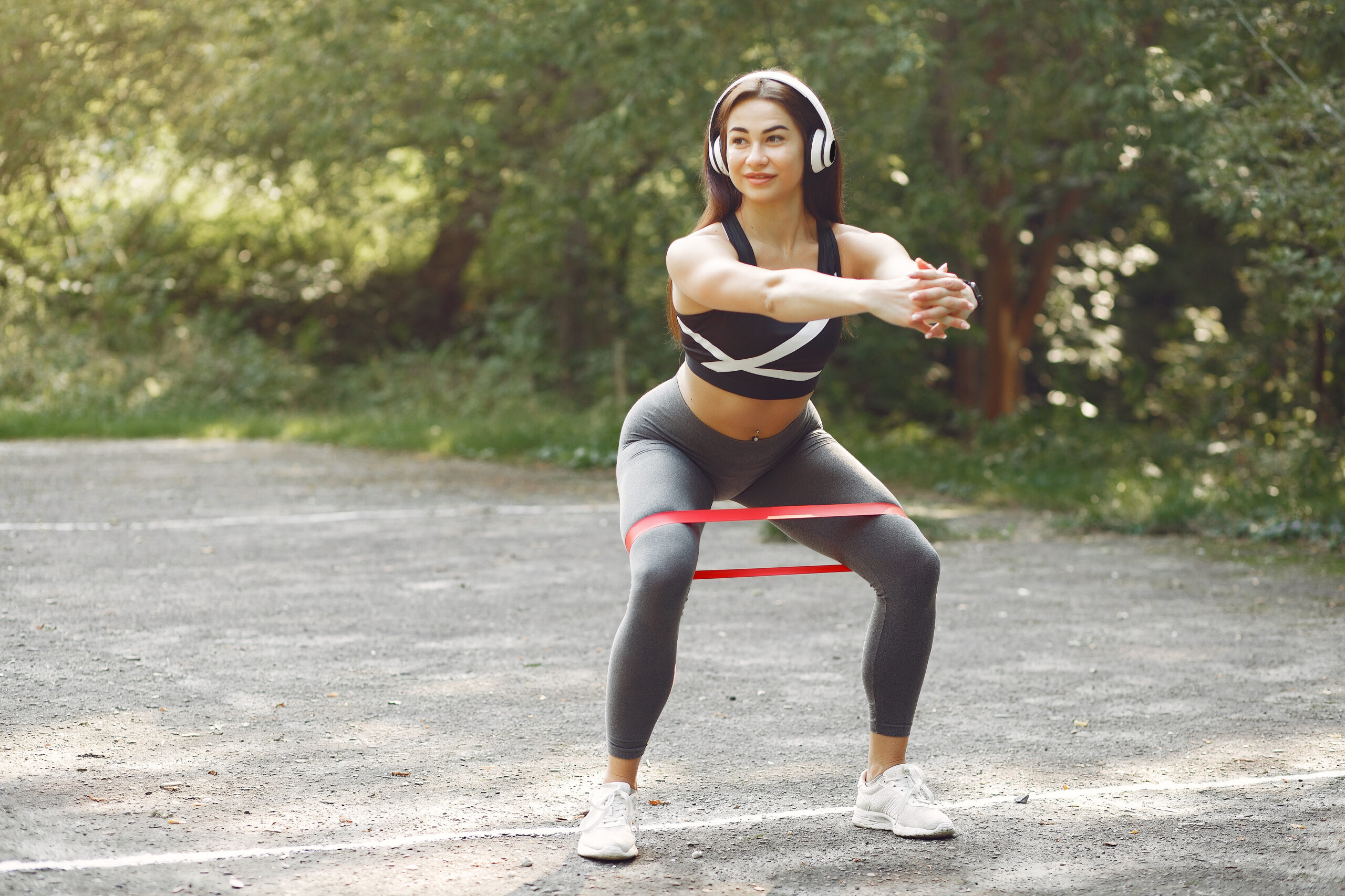 women squating using resistance band